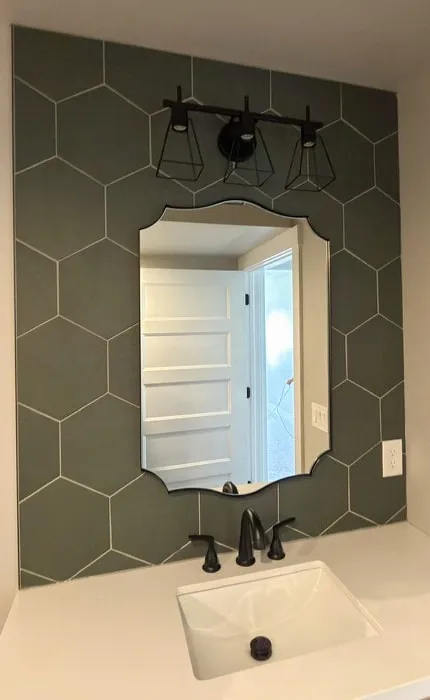 Hexagon tile feature wall behind a vanity with black fixtures